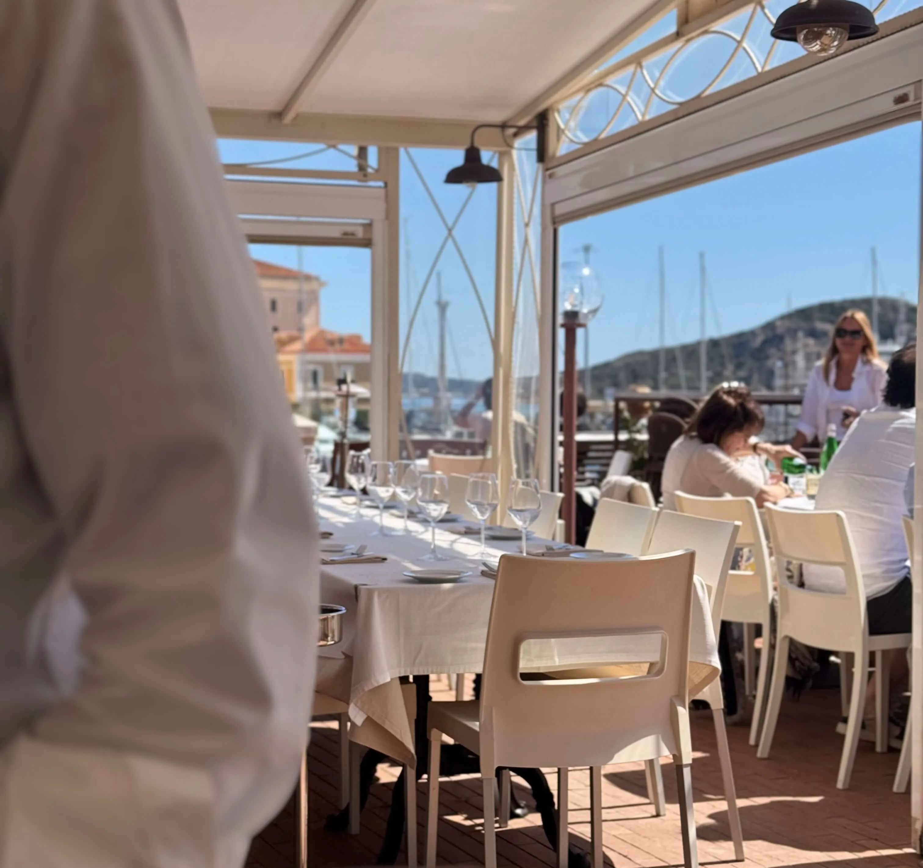 Tables carefully set on the panoramic terrace of Perla Blu